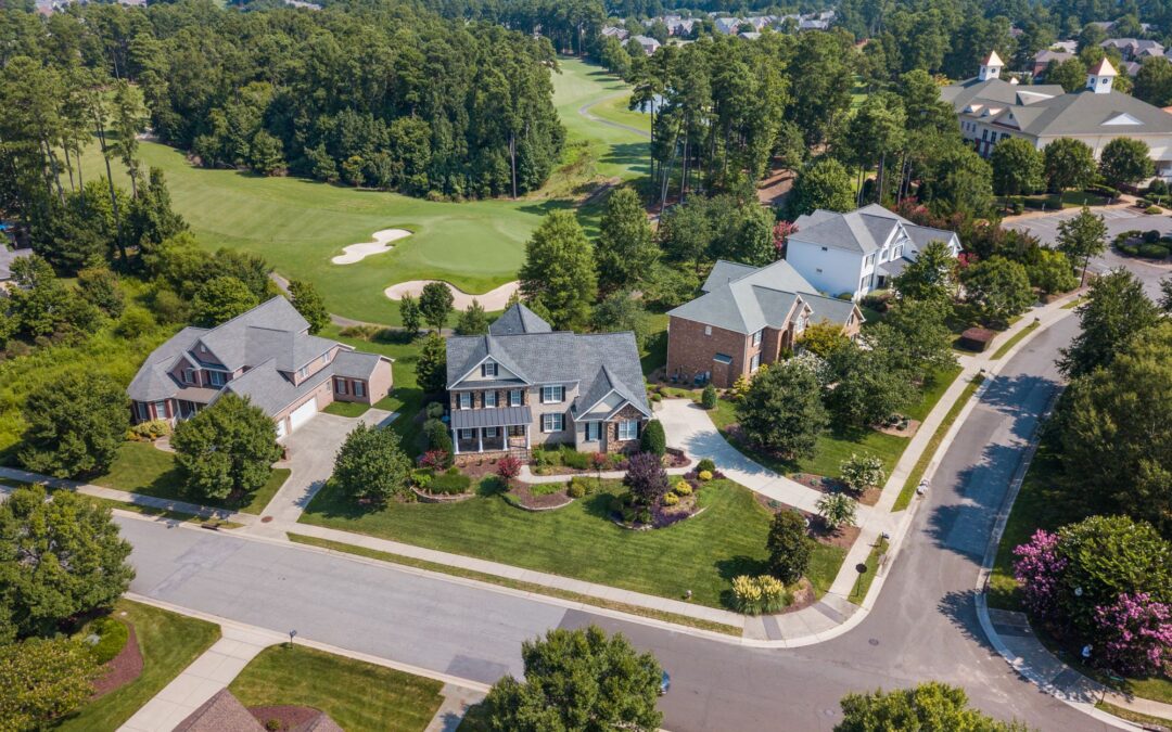 Aerial view of suburban neighborhood with lush greenery in Bastrop TX
